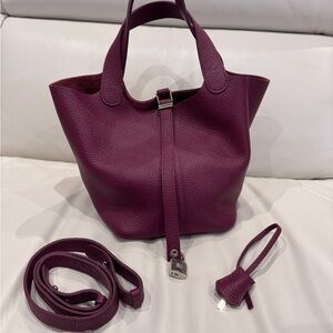 Burgundy color Leather Bucket Tote Bag with Lock Accent and a Shoulder Strap